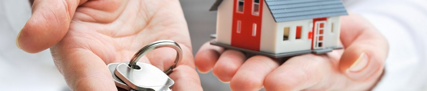 House and keys Real estate agent with house model and keys