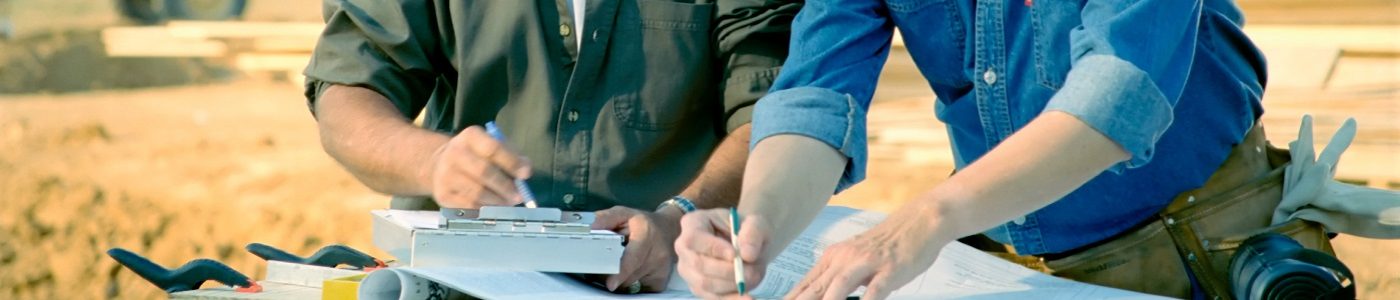 Construction workers look at and discuss plans. Construction workers look at and discuss plans.